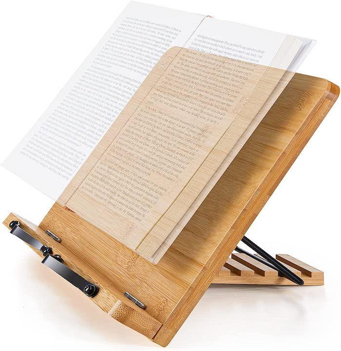 a bamboo book stand with a semi-transparent image of an open book hovering over it