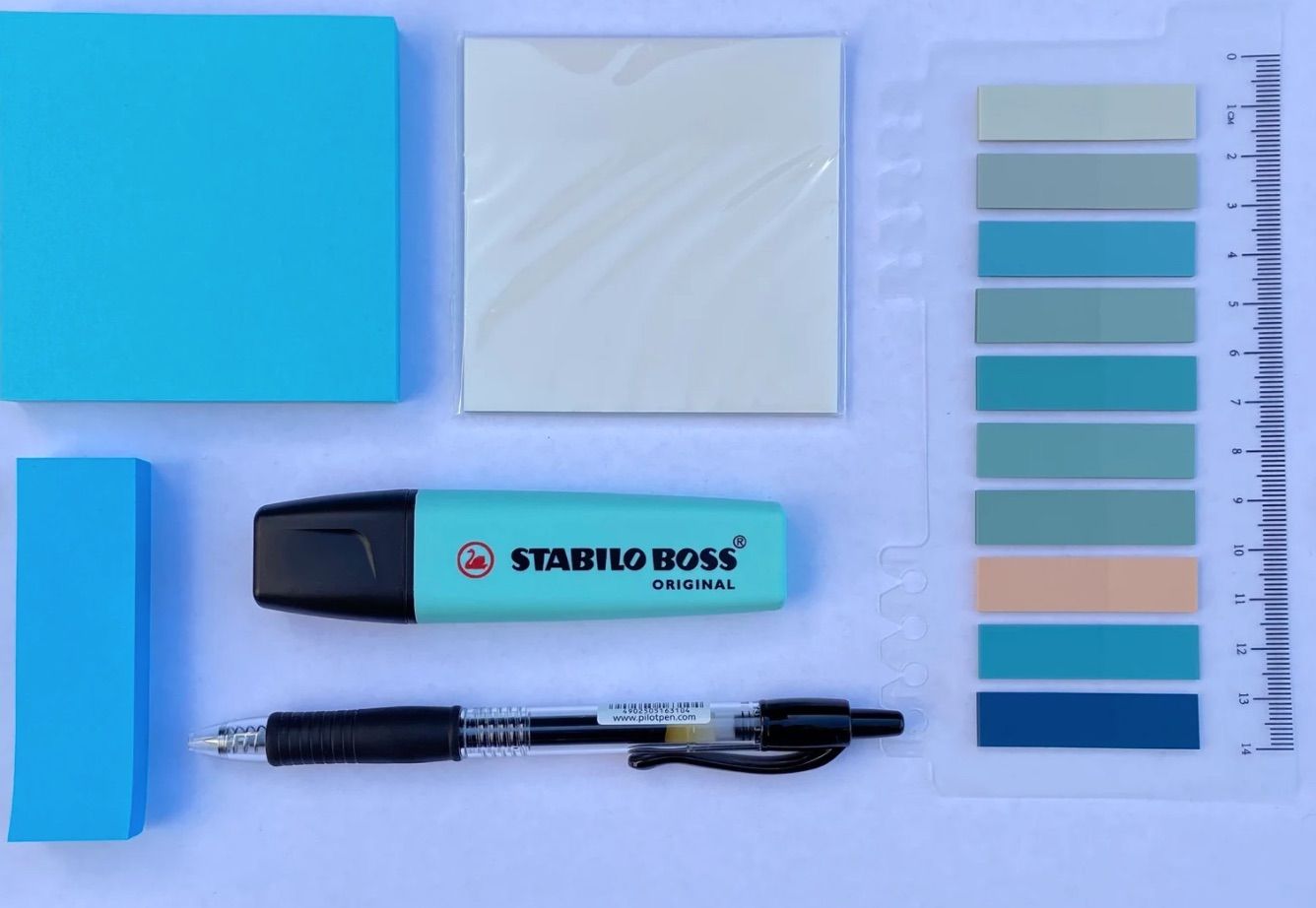 Image of a blue annotation kit, including sticky tabs, a highlighter, and a pen. 