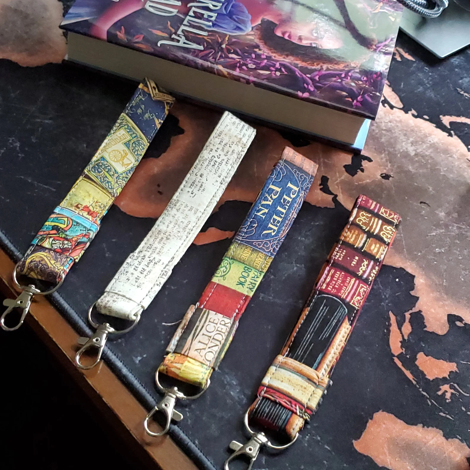 a selection of wristlet key fobs in various bookish prints
