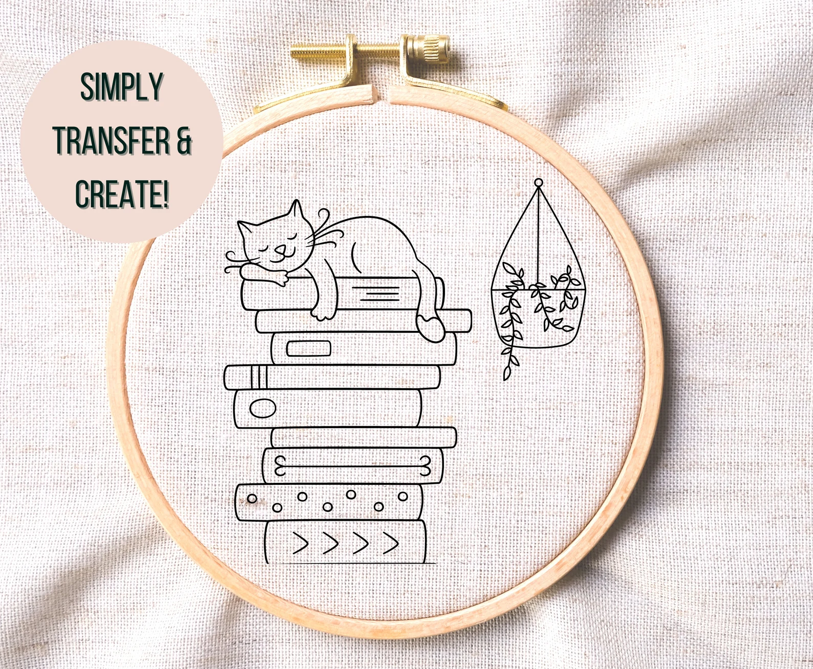 Image of an embroidery project that features a cat on a stack of books.