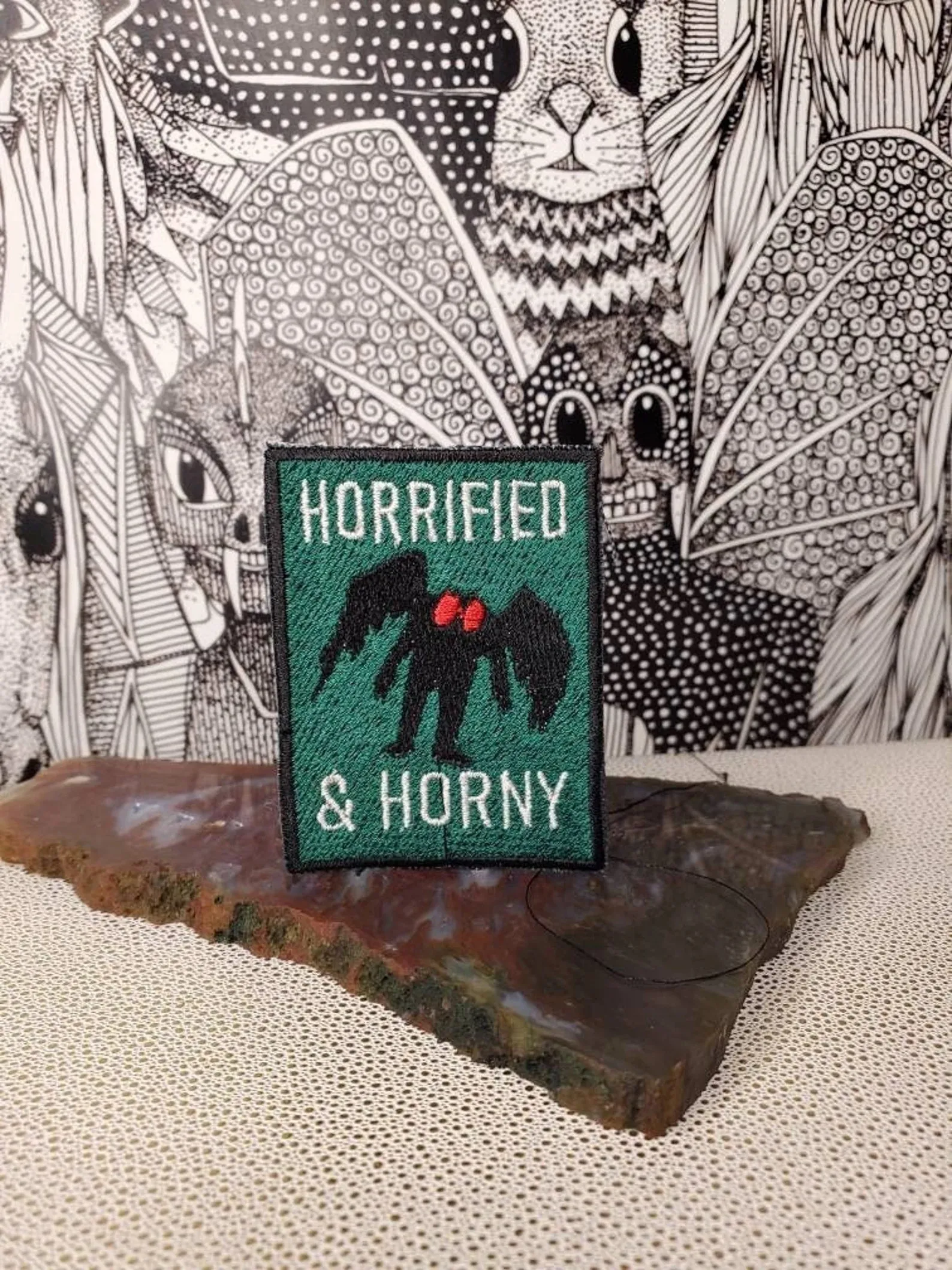 mothman patch that says horrified and horny