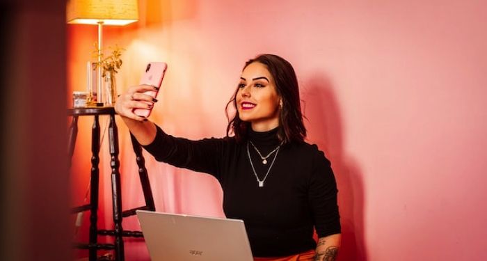 fair-skinned woman takes picture of herself