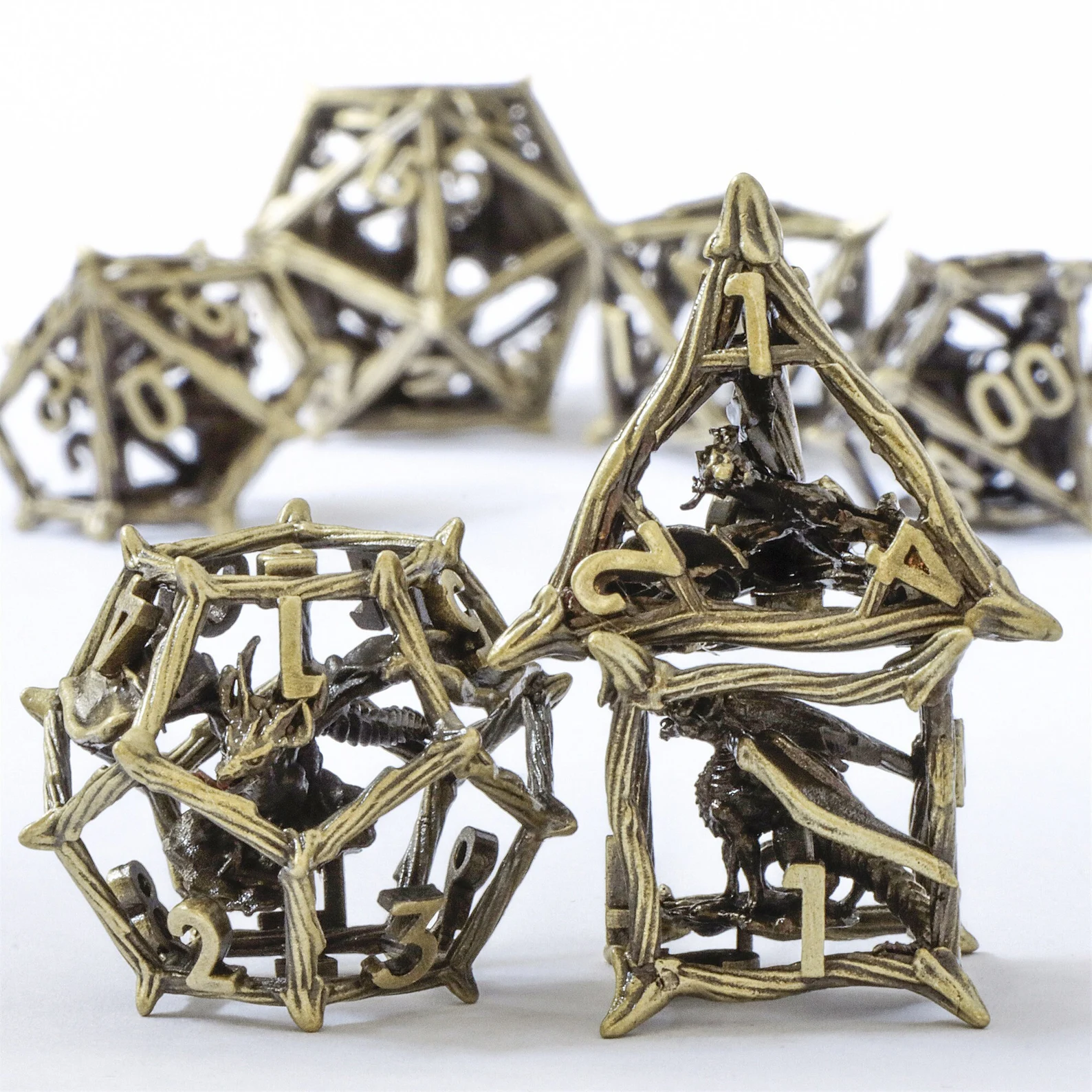 A photo of seven golden hollow metal dice with dragons inside. 