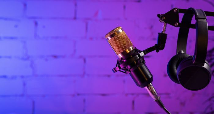 microphone and headphones on purple background