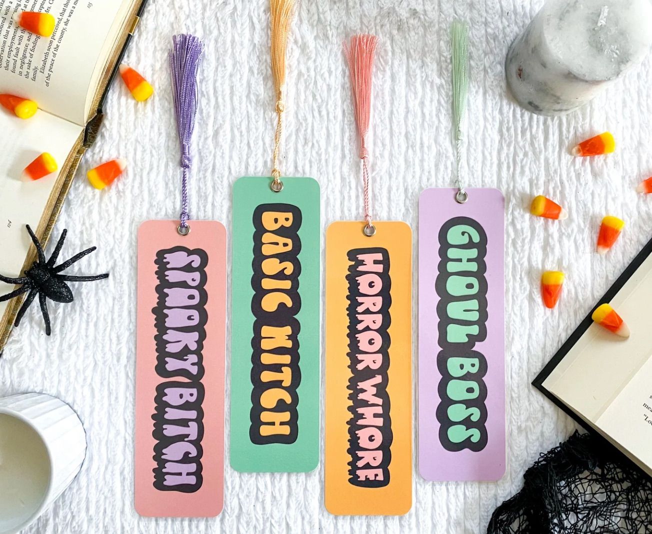 Image of four bookmarks in pastel colors. They read "spooky bitch," "Basic witch," "horror whore," and "ghoul boss."