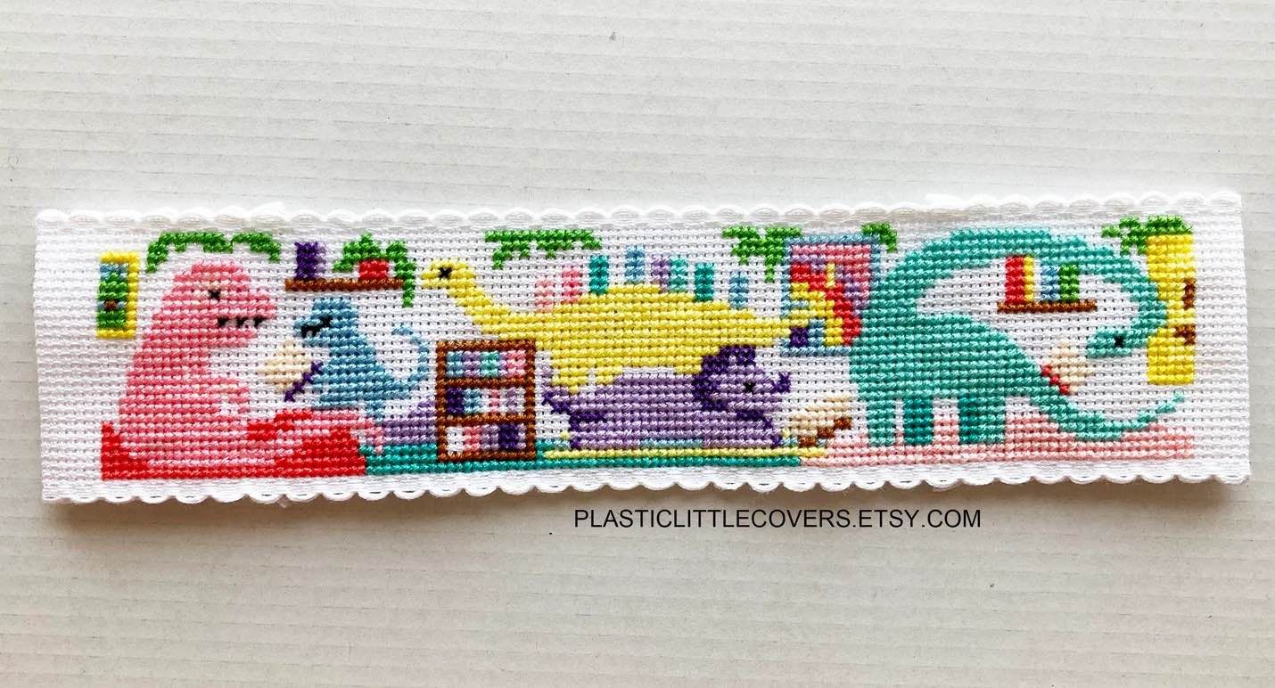a photo of a Dinosaur Library cross stitch bookmark