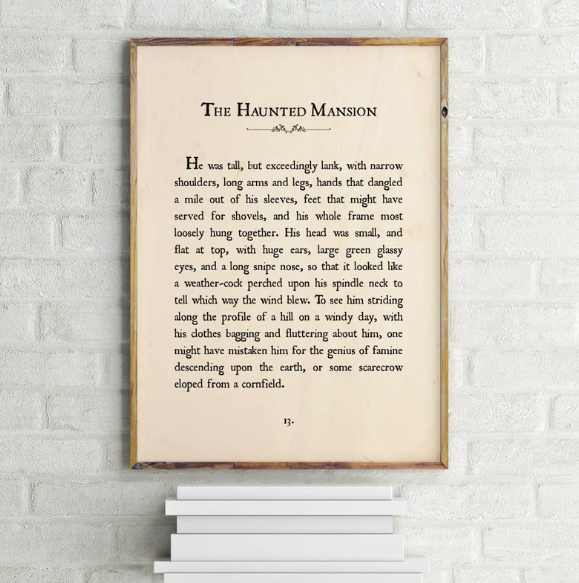 A framed print of the first page of The Haunted Mansion