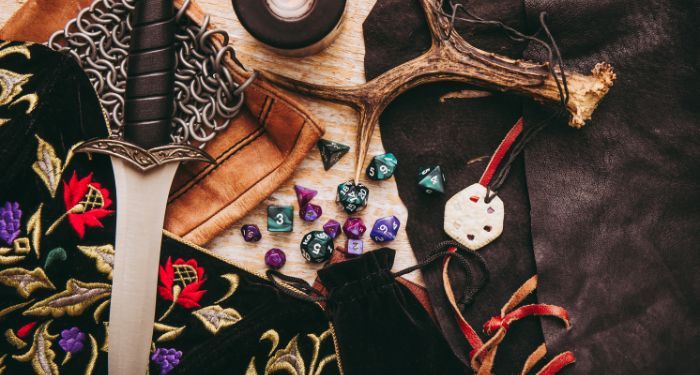 Dungeons and Dragons items including die, a fake sword, and other things

