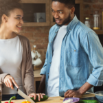 a photo of a Black couple cooking together