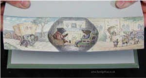 a photo of a fore-edge painting on Wind in the Willows, done by Martin Frost