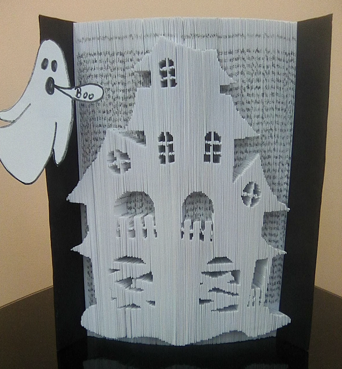 book with pages folded into a haunted house shape