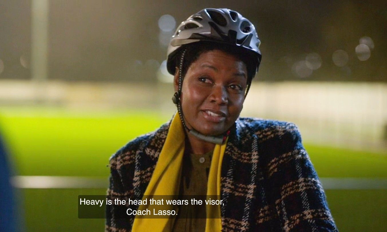 a screenshot from Ted Lasso showing Sharon saying, "Heavy is the head that wears the visor, Coach Lasso."
