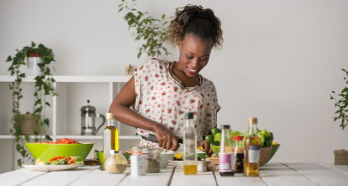 Image of a Black woman cooking in the kitchen