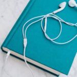 image of teal book with headphones on top