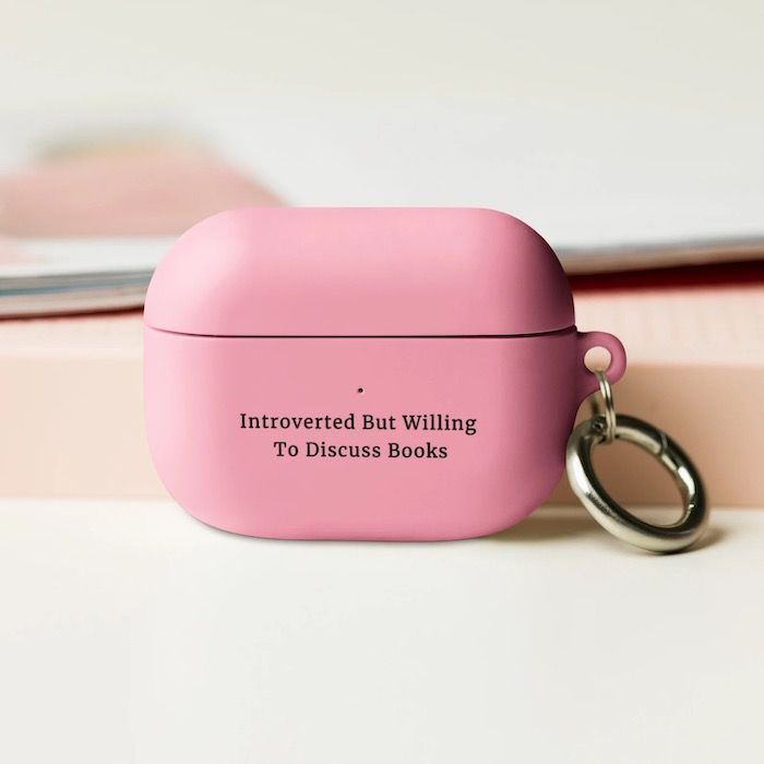 pink AirPod Pro case with black text that reads "Introverted But Willing to Discuss Books"