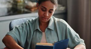 light brown-skinned woman reading a book