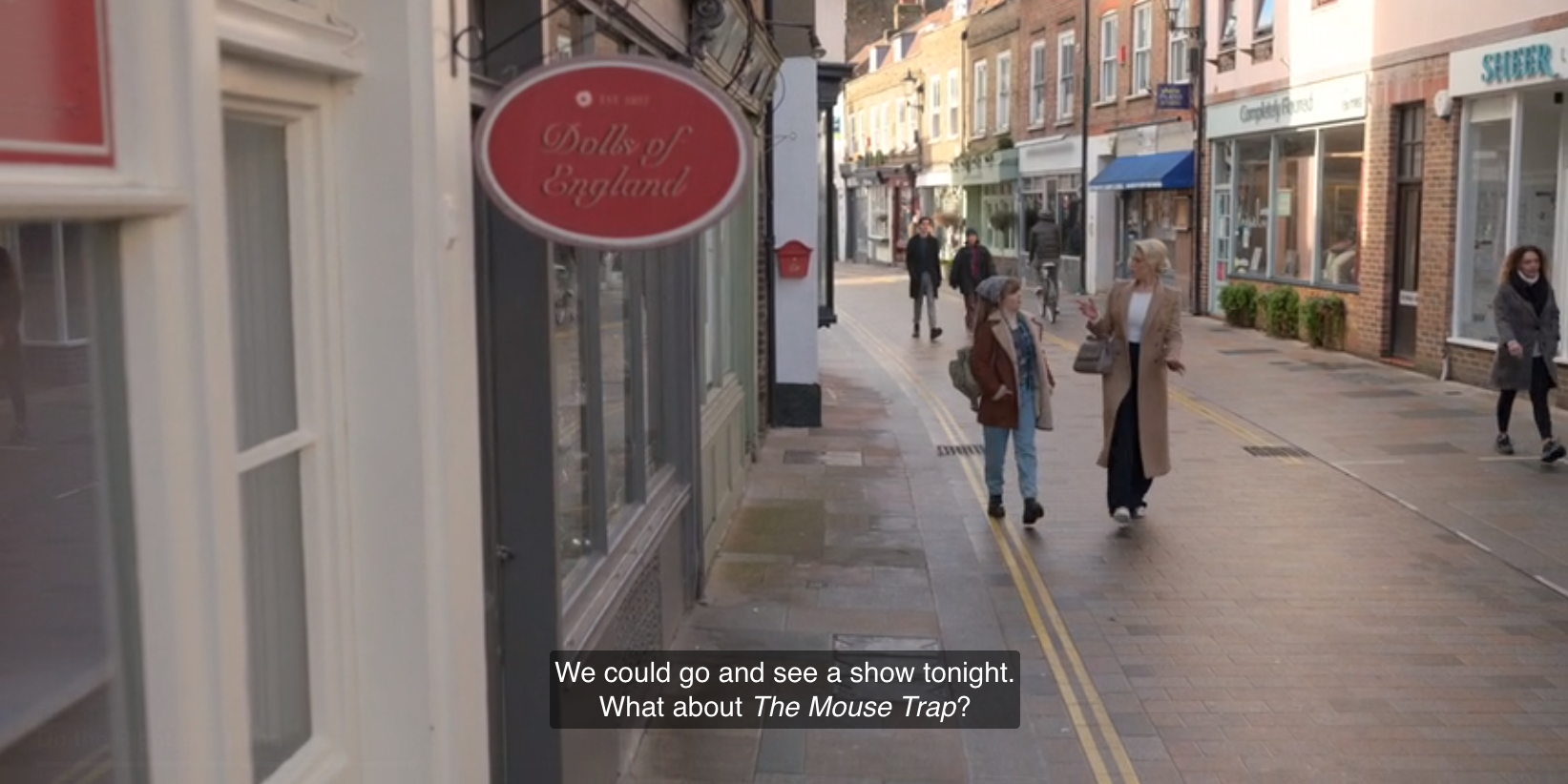 a screenshot from Ted Lasso showing Rebecca walking with her preteen niece, saying, "We could go and see a show tonight. What about The Mouse Trap?"