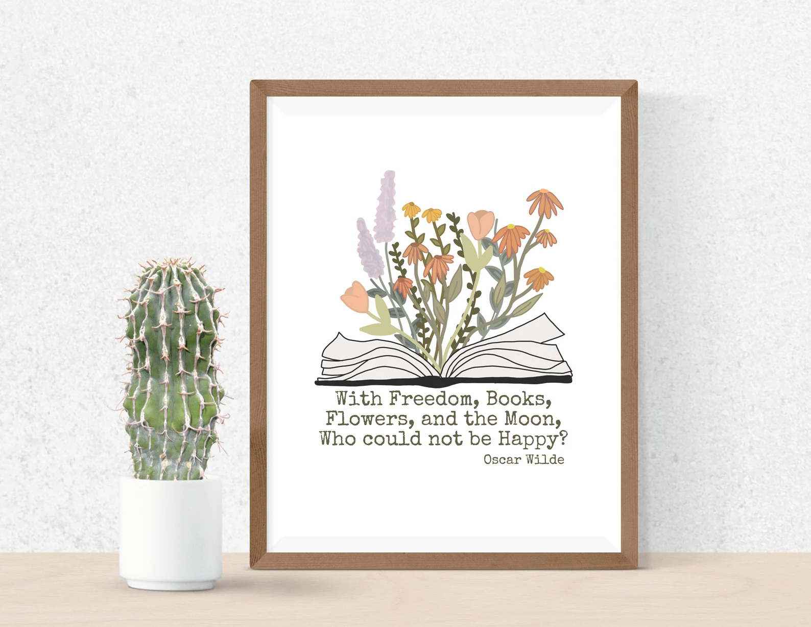 a photo of a framed poster with the text "With freedom, books, flowers, and the moon, who could not be happy?" - Oscar Wilde