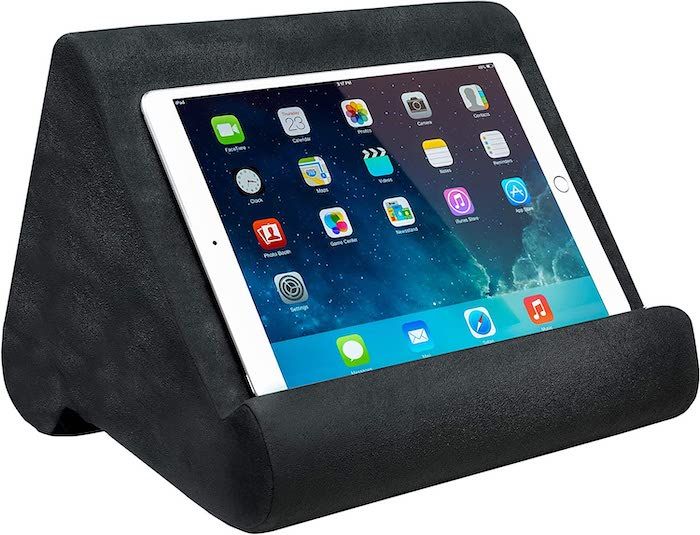 a dark grey Pillow Pad book and tablet stand with an iPad resting on it