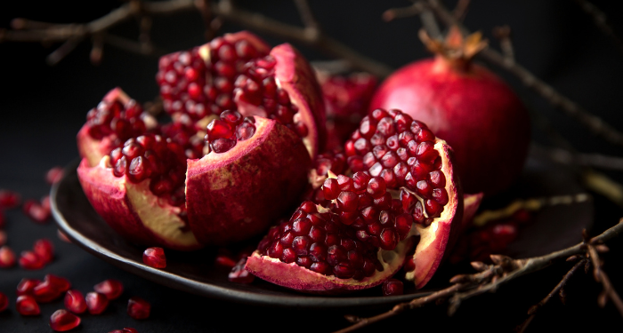a photo of pomegranates against a dark background
