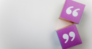 a photo of paper cubes displaying quotation marks