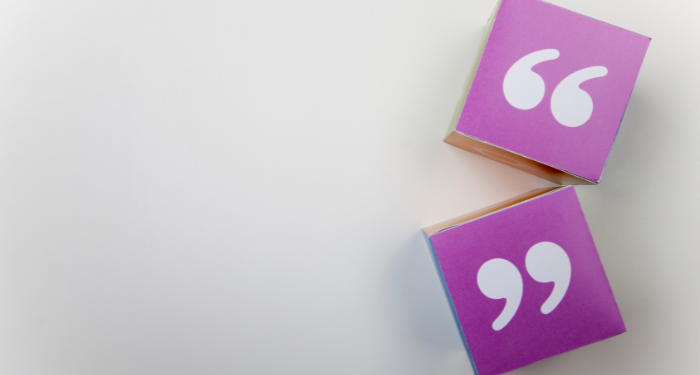 a photo of paper cubes displaying quotation marks