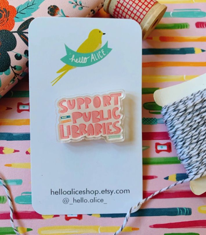 Image of a pin that says "support public libraries" in bright colors.