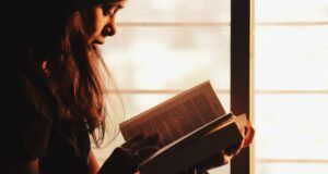 light brown-skinned woman reading
