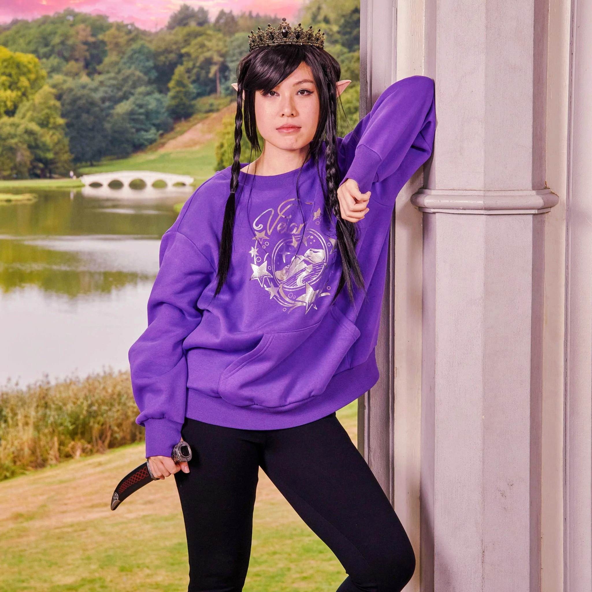 Purple crew neck sweatshirt with silver stars and a mountain on it