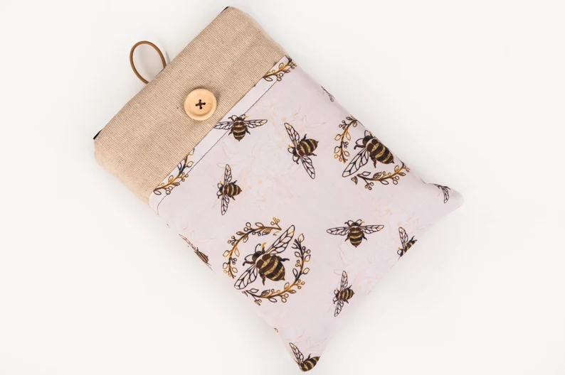 Photo of a white book sleeve with a print of bees