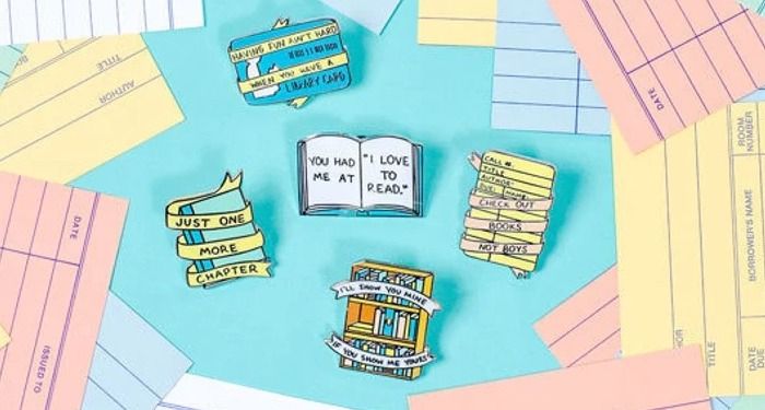 a photo of book enamel pins