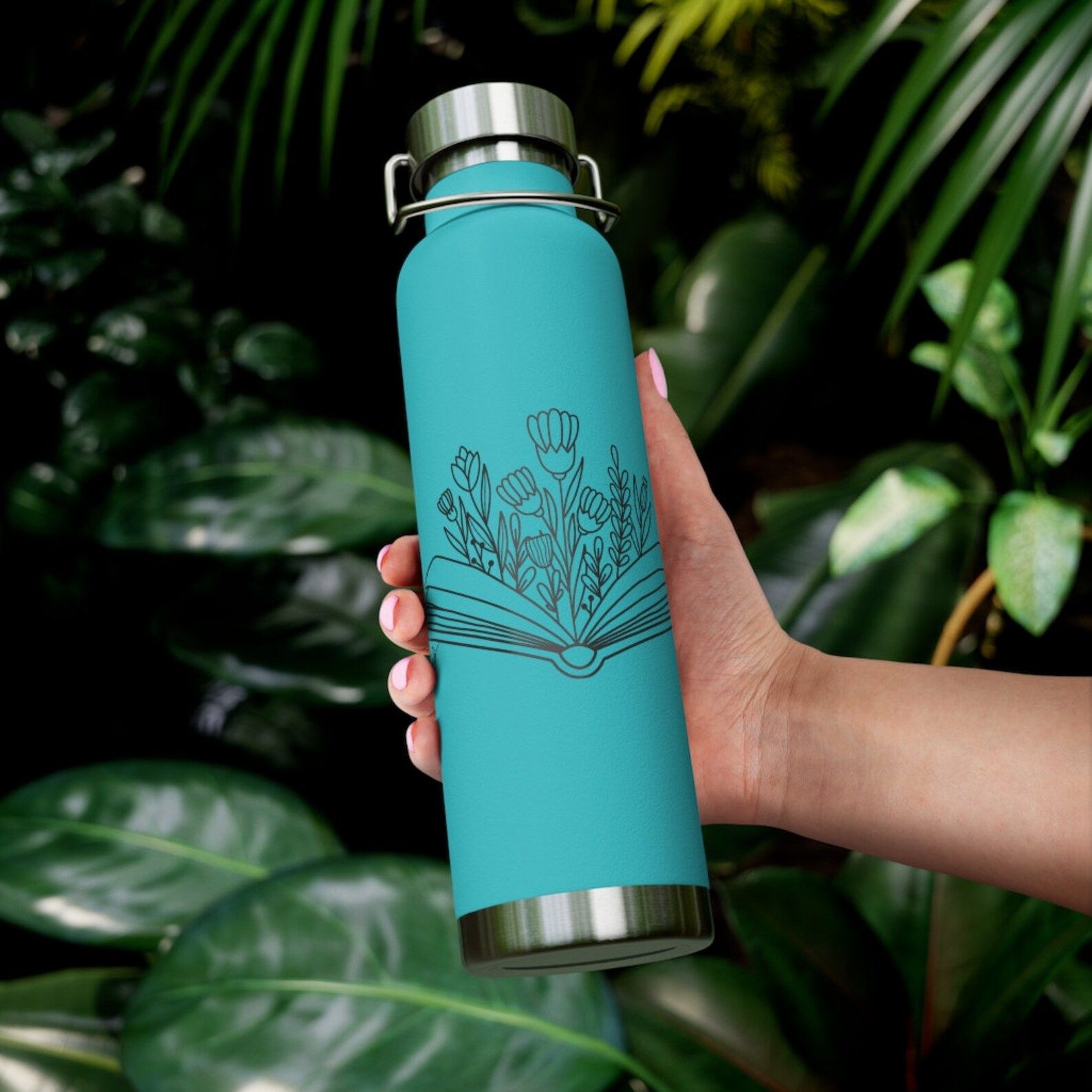 A blue insulated water canteen with an open book and flowers blooming out of it.