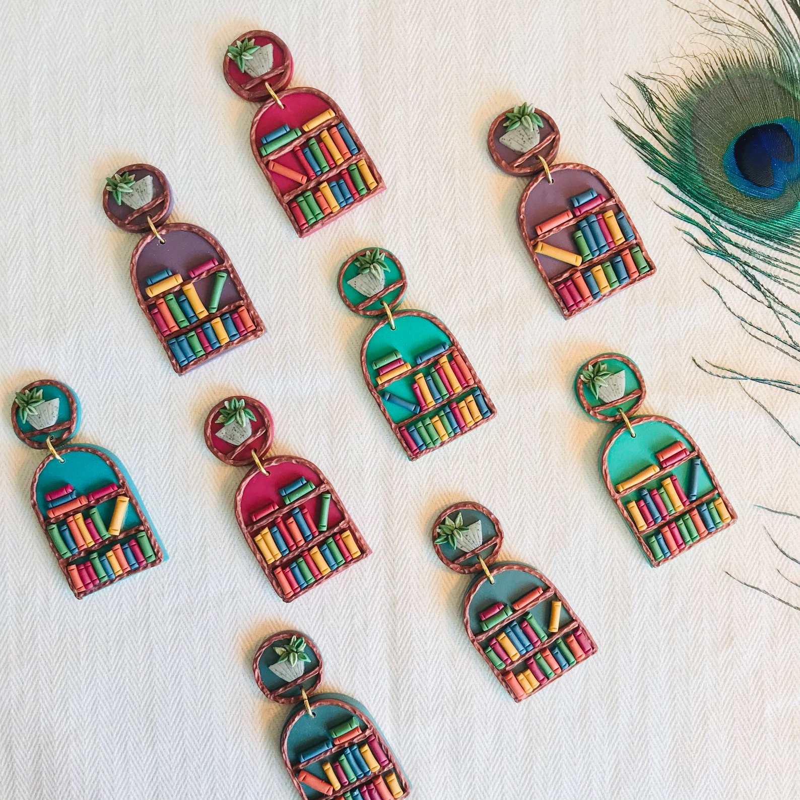 large earrings with colorful bookshelves and plants