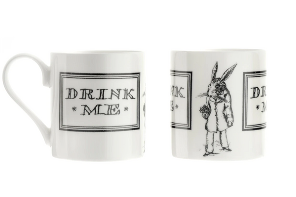 White Alice in Wonderland Mug with black outline text within a black square border reading "DRINK ME" on both sides with an illustrated White Rabbit in-between. 