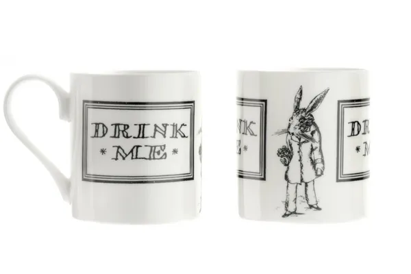 White Alice in Wonderland Mug with black outline text within a black square border reading "DRINK ME" on both sides with an illustrated White Rabbit in-between. 