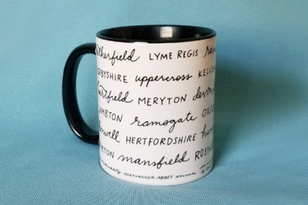 White mug with black handle and interior covered in cursive place names from Jane Austen novels like "Meryton" and Lyme Regis."