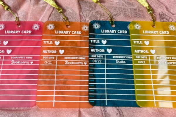 Colorful semi-transparent acrylic bookmarks designed to look like library card book inserts.