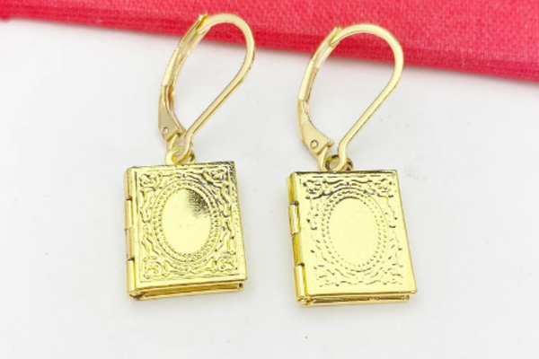 Gold locket earrings in the shape of a book.