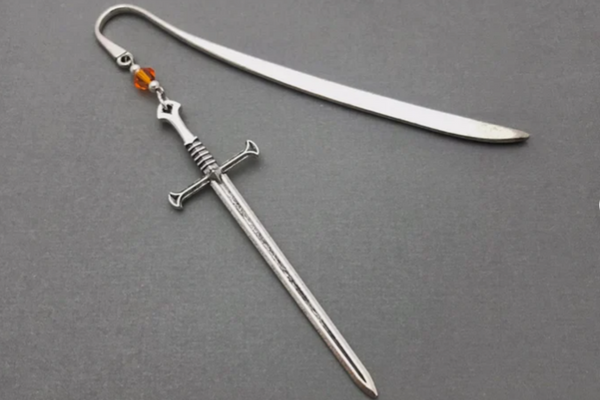 Silver metal bookmark with a sword that will dangle over the spine.