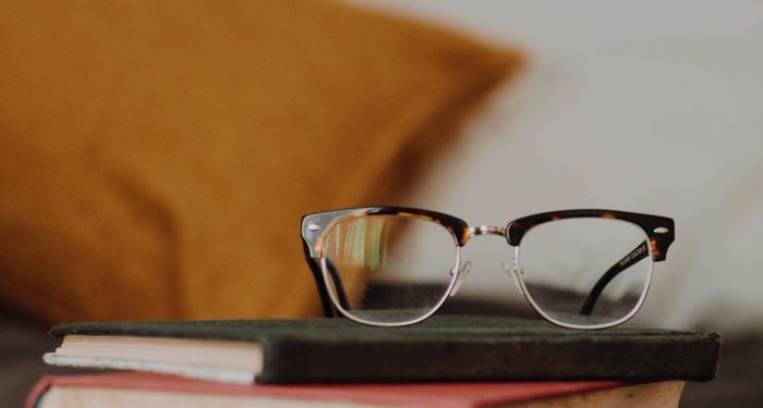 glasses on top of books