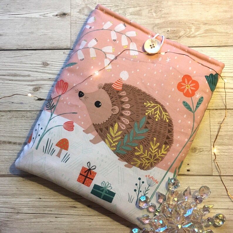 Photo of a white and pink book sleeve with a print of a hedgehog