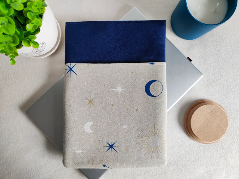 Photo of a blue and beige book sleeve with a print of stars and moons