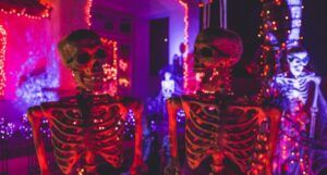 two skeletons with lights in the background