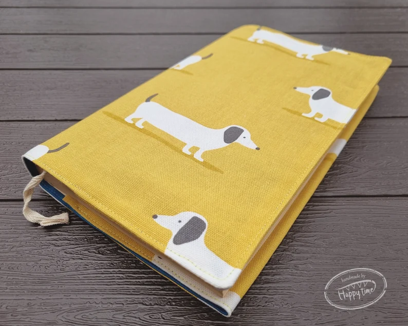 Photo of a yellow book sleeve with a print of a white dog