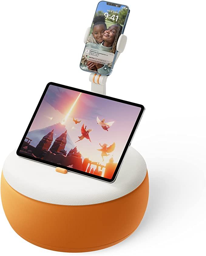 A round orange pillow with a flexible stand for holding phones, ereaders, or tablets.  