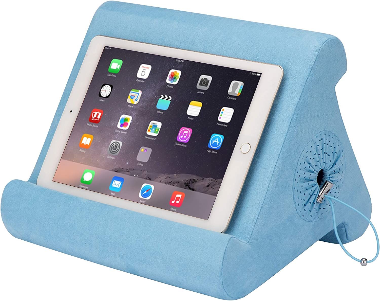 A triangular blue pillow with a lip for holding a tablet. It has a hollow in the center for holding other items. 