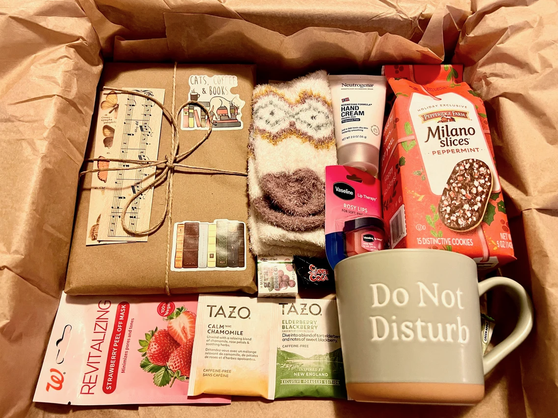 Book subscription box featuring tea, cookies, a mug, and a book