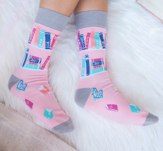 Pink socks with blue, turquoise, peach, and dark blue books. 