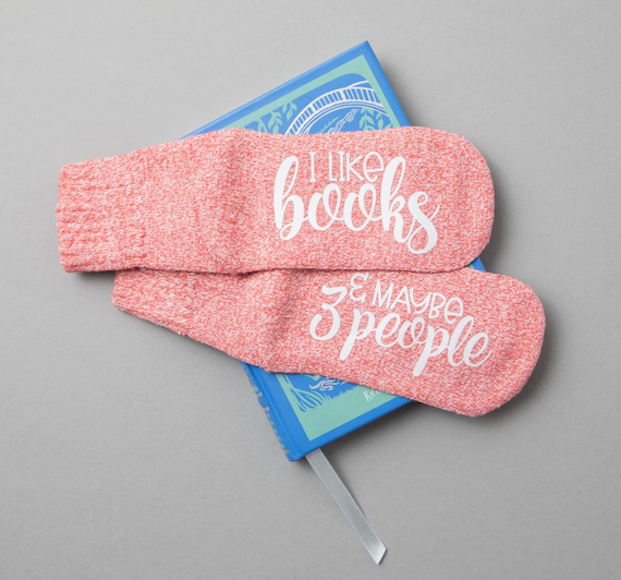 Peach socks with the text "I like books" (one foot) "& maybe 3 people." (other foot)