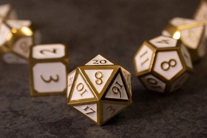 Image of dnd dice set with white enamel panels, gold numbers and gold edges